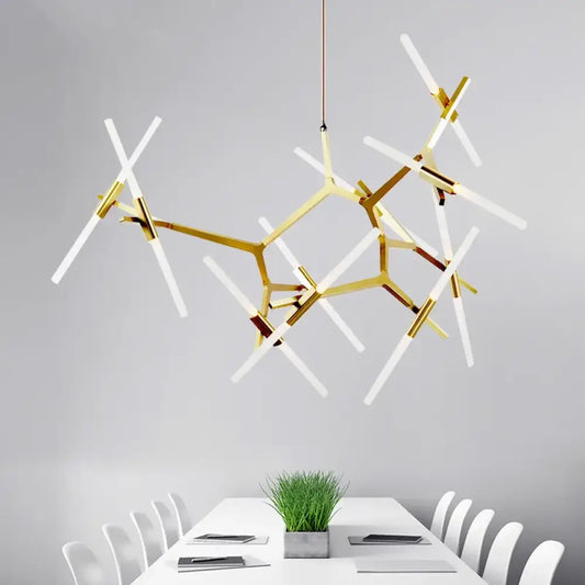 Gold modern LED multi-head chandelier hanging above a kitchen island in a bright kitchen