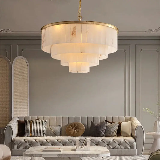 Gold frame LED chandelier with natural marble accents in a modern living room