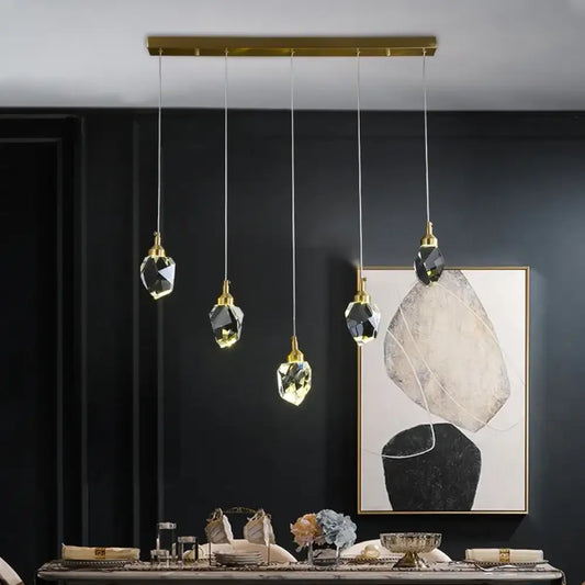 Linear Nordic crystal LED pendant light with multiple heads above a kitchen island