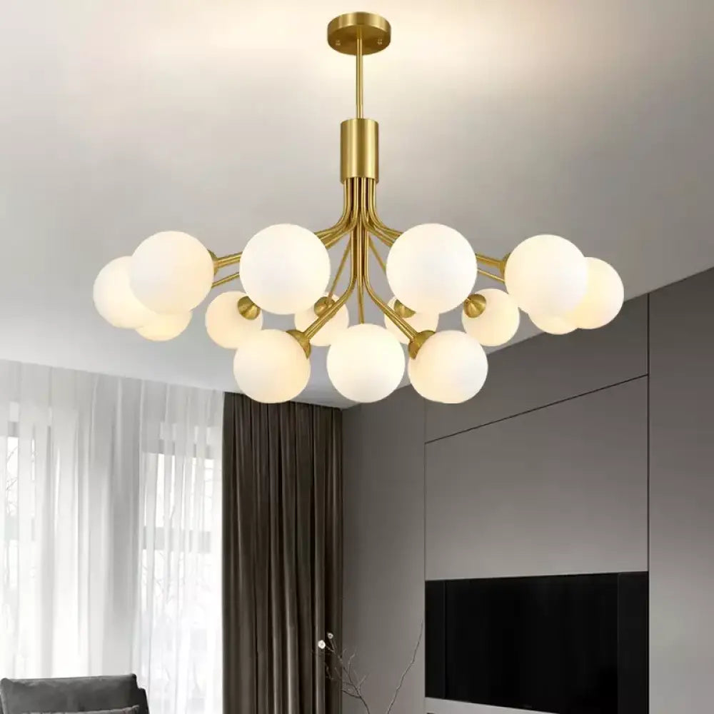 Gold Nordic glass ball chandelier with branching globes over a dining table