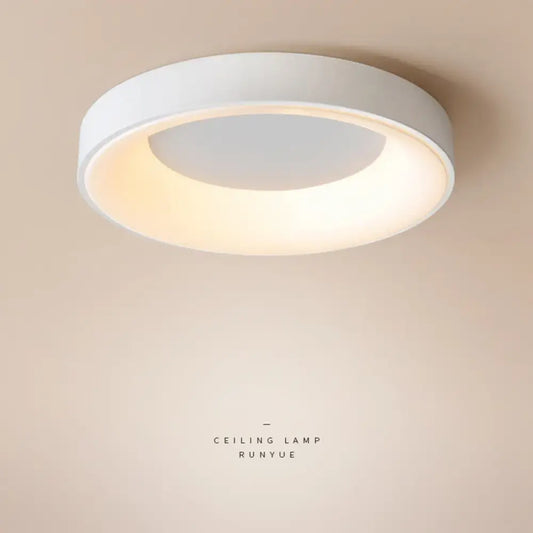 Black Nordic modern LED ceiling light in a minimalist bedroom