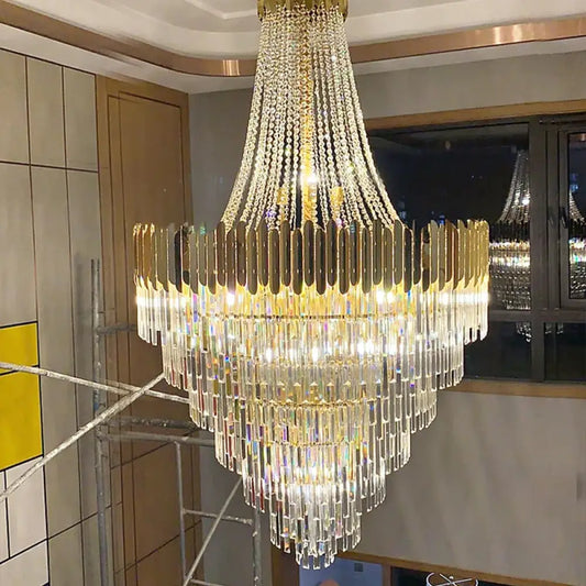 Tall Nordic crystal LED chandelier hanging in a double-height foyer with staircase