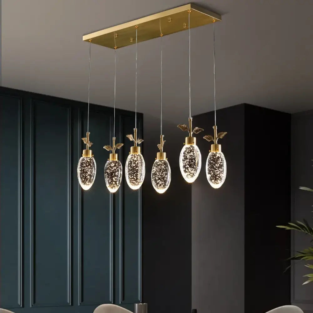 Copper crystal LED pendant chandelier with three heads over a kitchen island