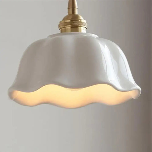White Nordic ceramic LED pendant light hanging over a kitchen island in a modern kitchen
