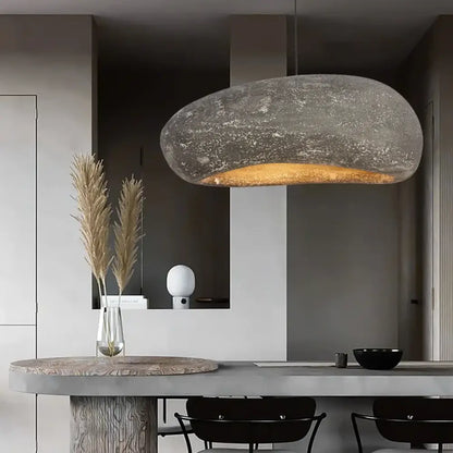 Nordic retro Wabi-Sabi LED pendant light with an artistic shade hanging over a dining table