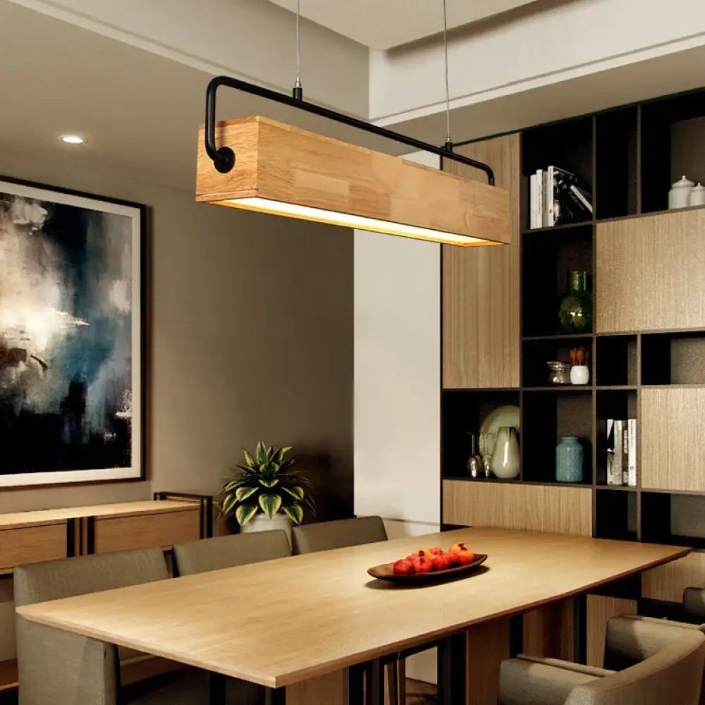 Nordic wood LED linear pendant light hanging above a kitchen island in a bright modern kitchen