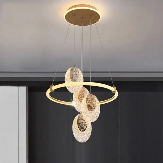 Modern double ring LED pendant light glowing above a round dining table in a contemporary home