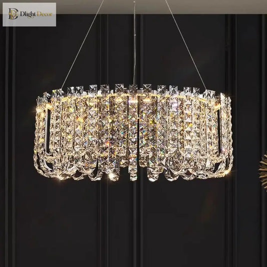 Two-tier round crystal LED chandelier above a dining table in a modern home
