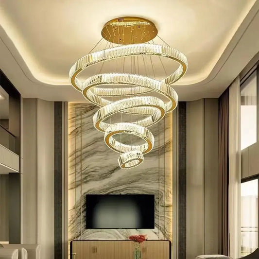 Gold multi-ring crystal chandelier hanging in a bright duplex living room