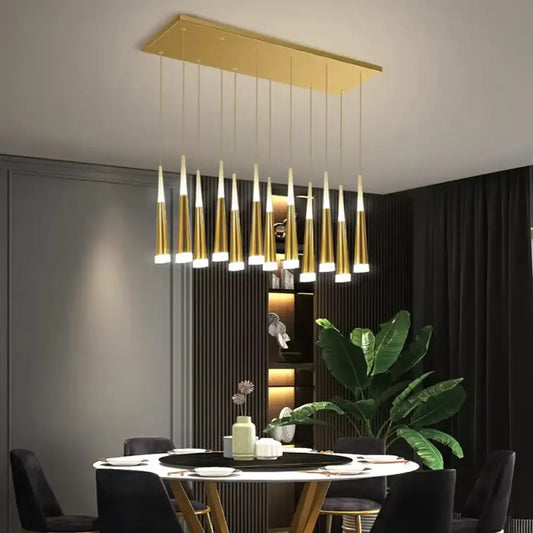 Golden modern multi-head pendant light hanging above a dining table in a stylish dining room