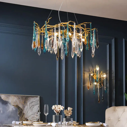 Modern LED chandelier with multi-color glass drops and gold frame hanging in a bedroom