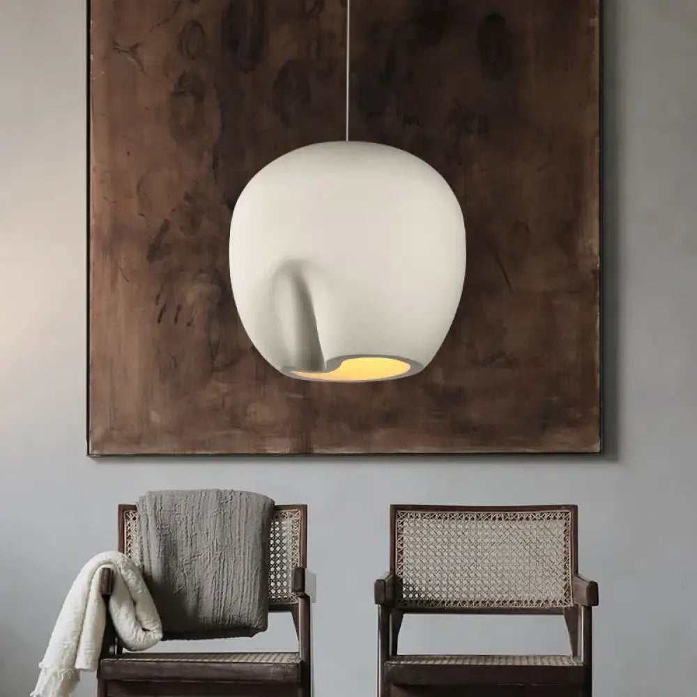Nordic minimalist Wabi-Sabi art pendant light glowing softly in a calm modern bedroom