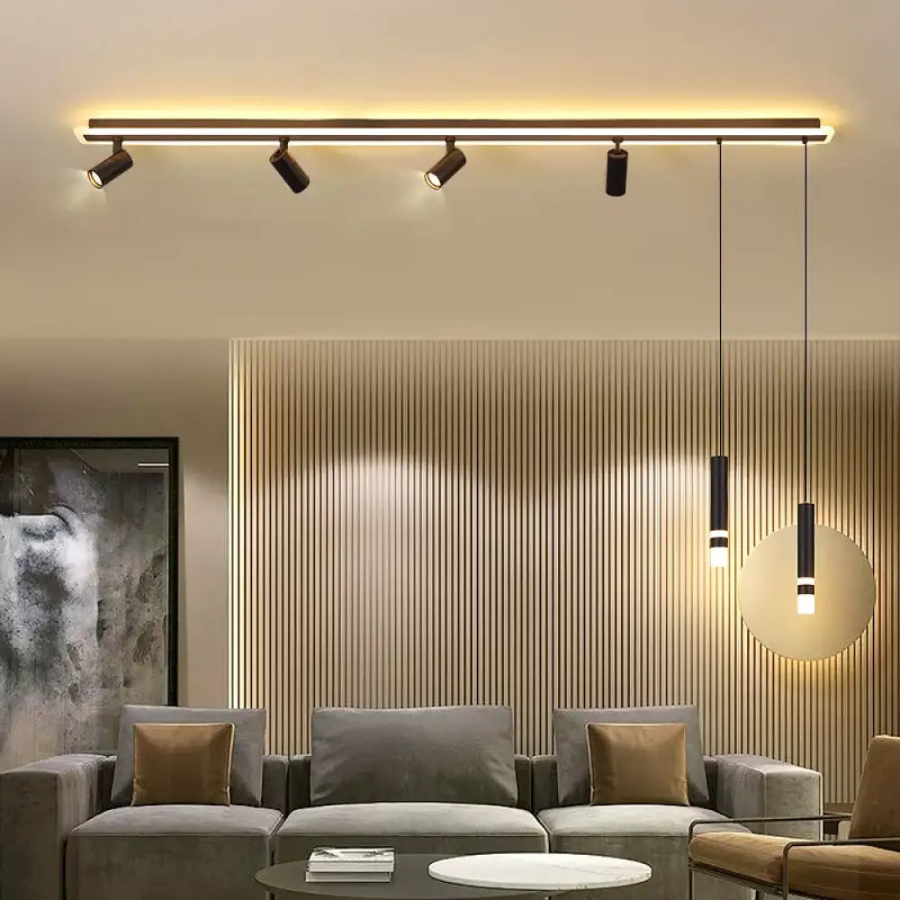 Nordic linear spotlight pendant light hanging over a long dining table in a modern home