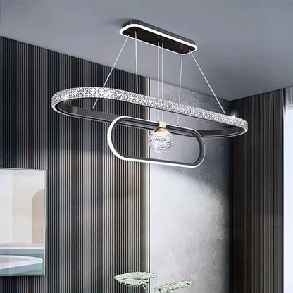 Black Nordic Signature chandelier glowing above a dining table in a Scandinavian dining room