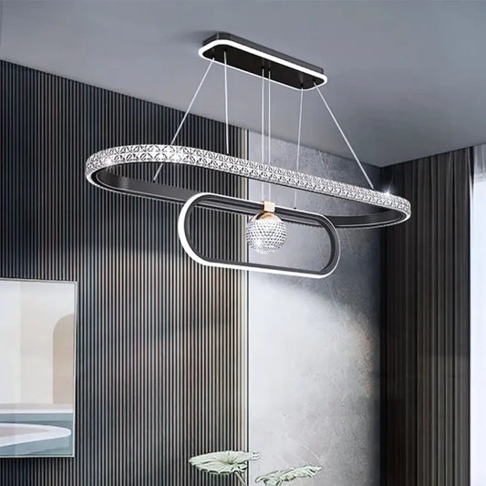 Black Nordic Signature chandelier glowing above a dining table in a Scandinavian dining room