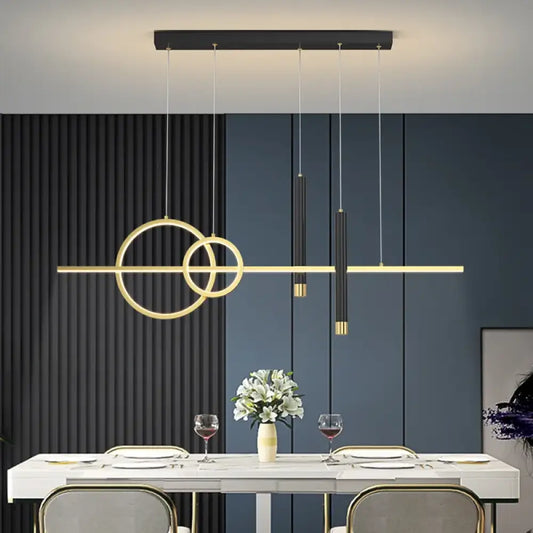 Black and gold contemporary LED linear pendant light hanging above a modern kitchen island