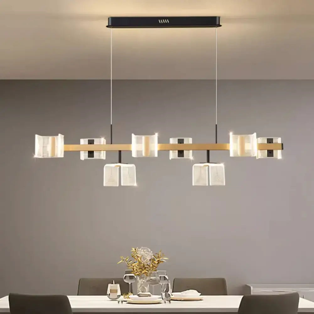 Signature modern multi-head LED chandelier pendant light glowing over a dining room table