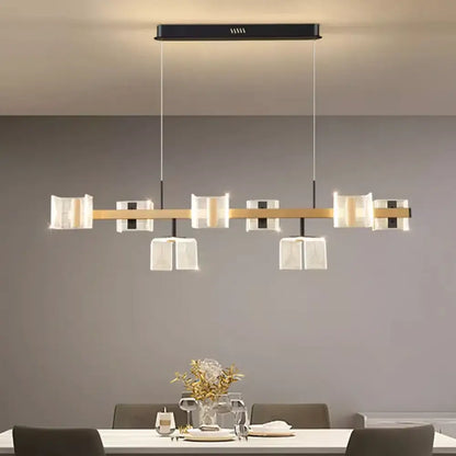 Signature modern multi-head LED chandelier pendant light glowing over a dining room table