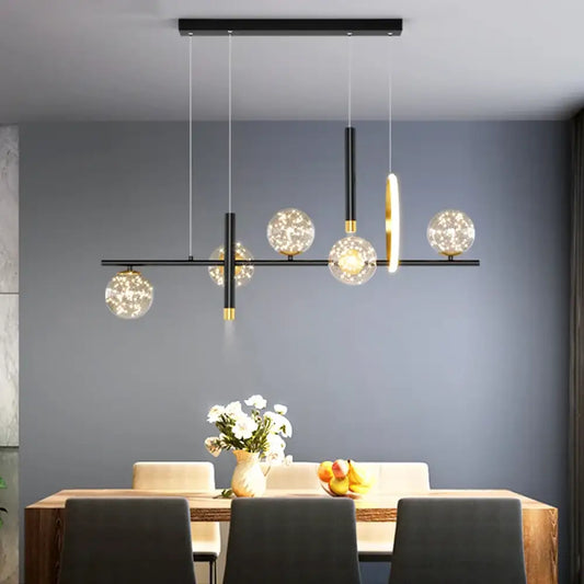 Black linear five-head Signature pendant light hanging above a dining table in a modern home