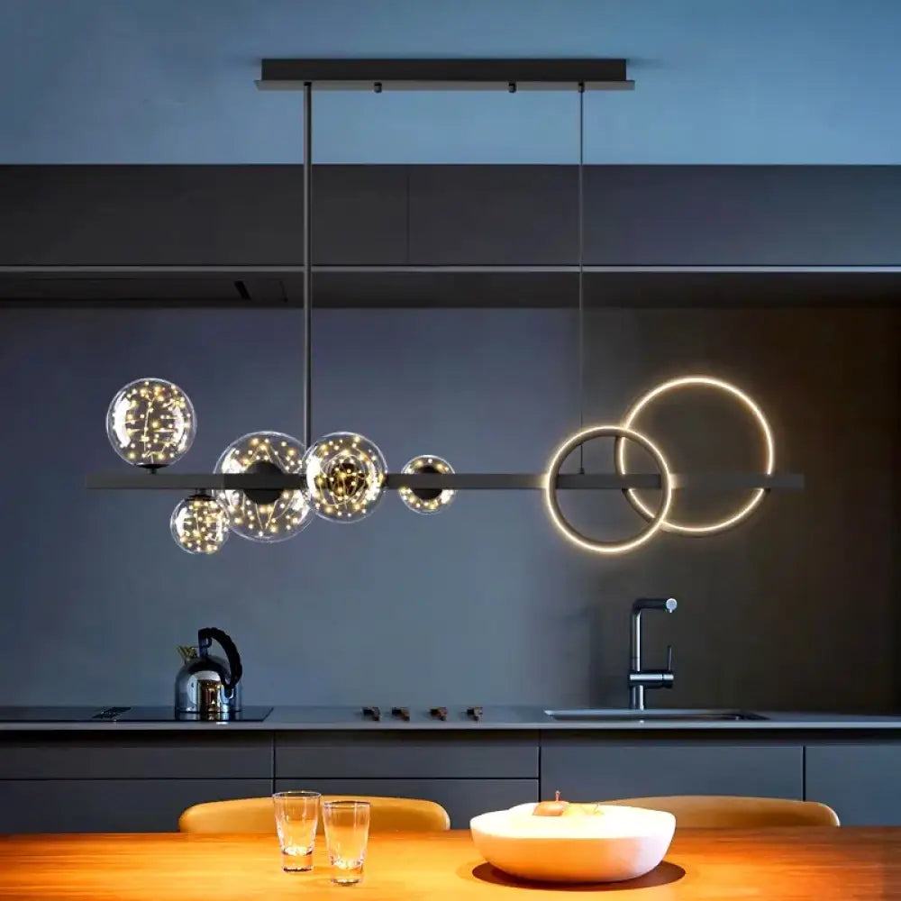 Sleek black modern 95 cm LED pendant light hanging over a dining table in a living space