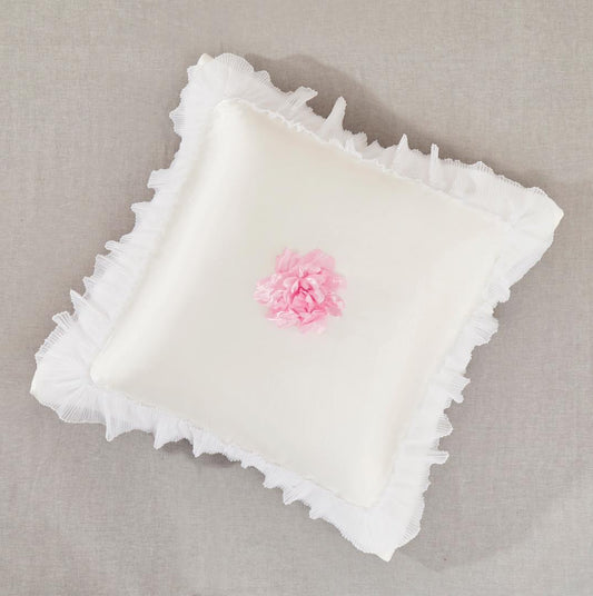 Pearl white satin euro sham with pleated ruffles and pink rose accents on a romantic bed
