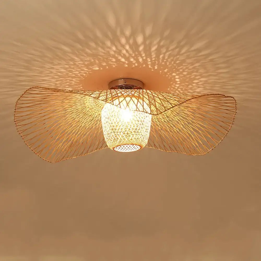 Tala woven bamboo Tatami-inspired pendant light hanging above a wooden dining table