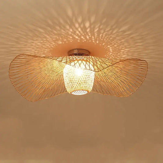 Tala woven bamboo Tatami-inspired pendant light hanging above a wooden dining table