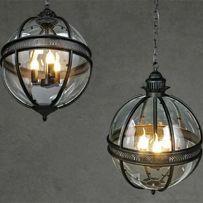 Black vintage glass globe pendant light hanging over a dining table near a covered patio
