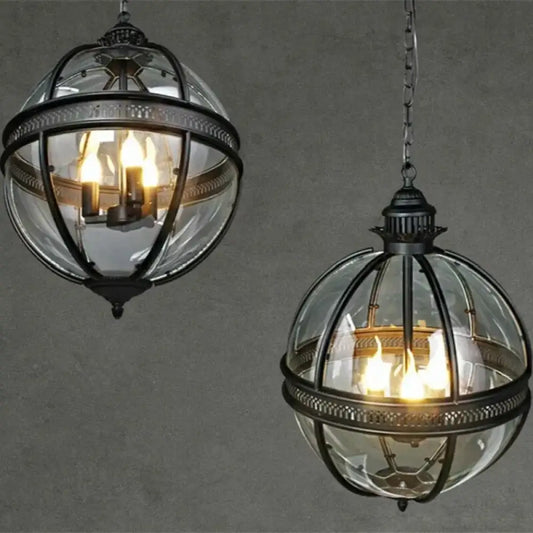 Black vintage glass globe pendant light hanging over a dining table near a covered patio