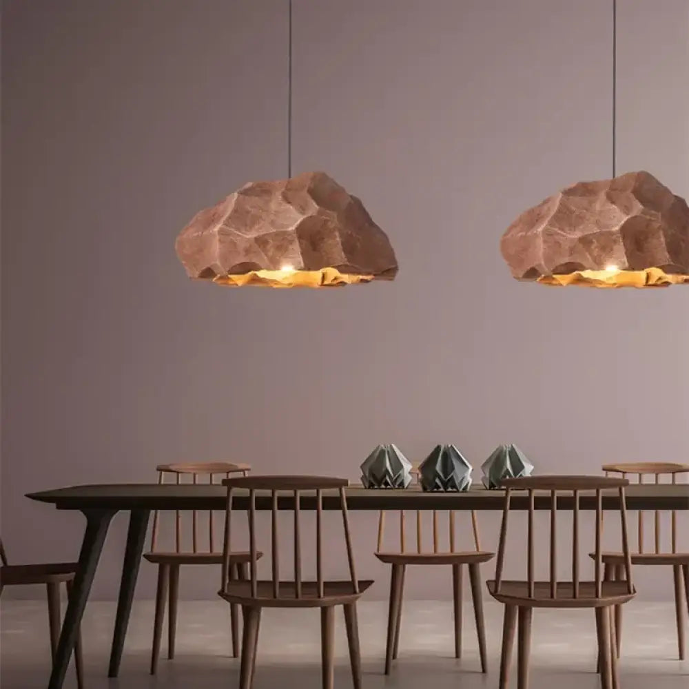 Grey rock Wabi minimalist LED pendant light hanging above a bedside table in a calm bedroom