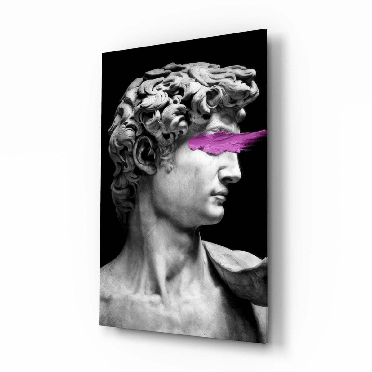 Black and white David bust with magenta paint stripe glass wall art in a creative loft
