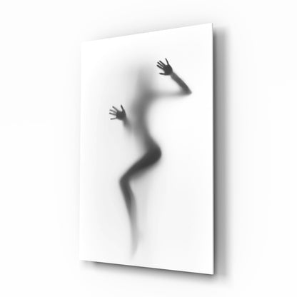 Black and white woman silhouette behind frosted glass wall art hanging in a modern primary bedroom