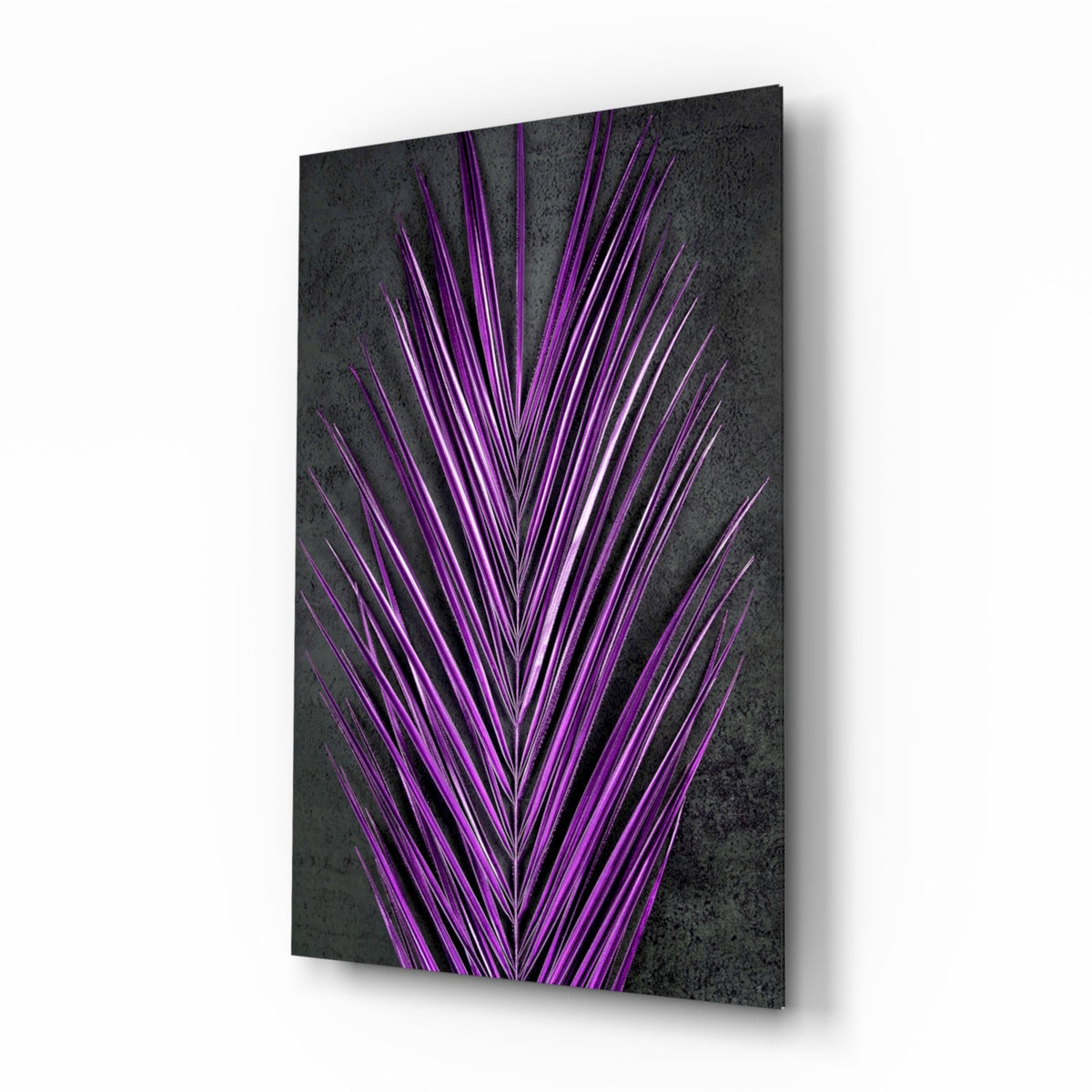 Bright purple areca palm frond on dark slate glass wall art in a modern-tropical bedroom