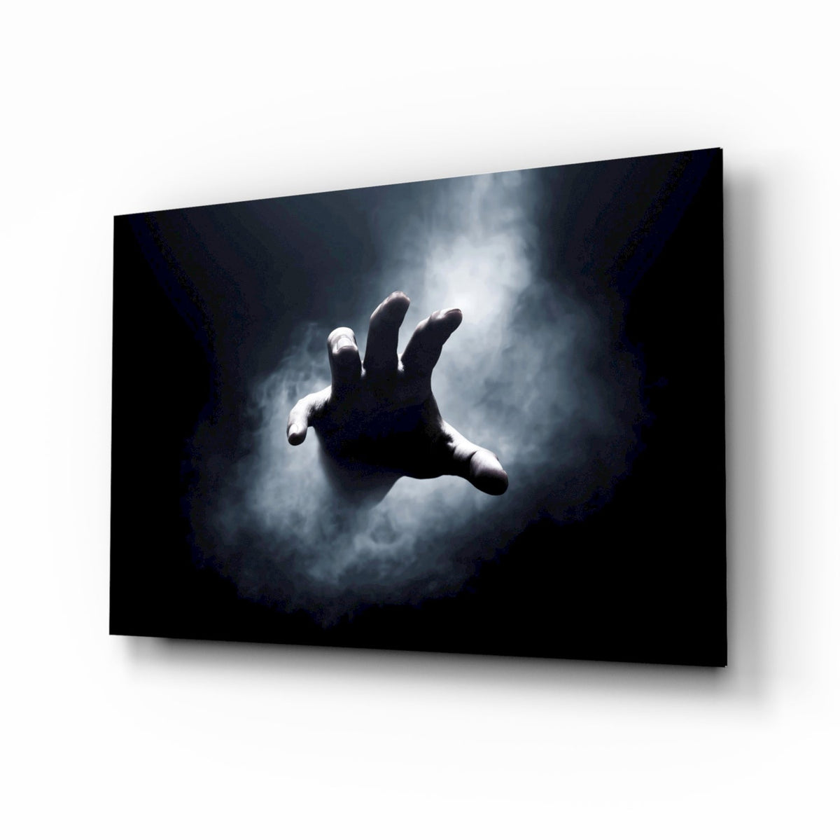 Pale hand reaching through fog from black void glass wall art in a home theater