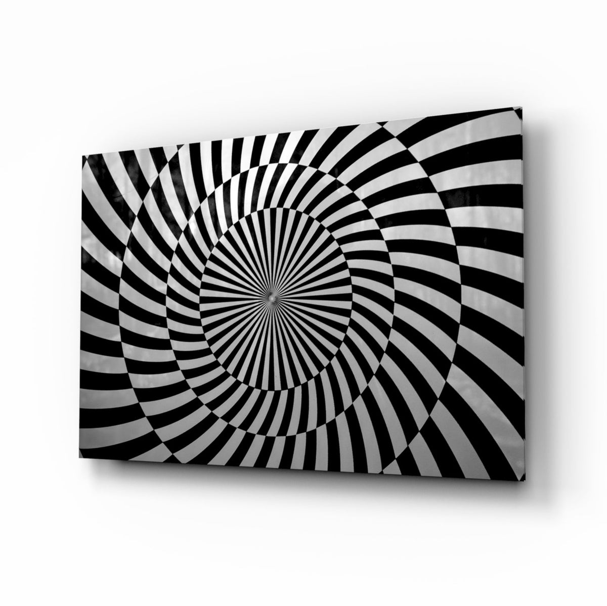 Black and white optical spiral op-art glass wall art in a modernist living room